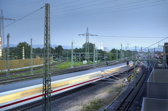 [Translate to Französisch (CH):] Ein Zug der Deutschen Bahn inmitten von Strommasten.